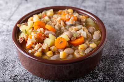 Spelled and legume soup served on an earthenware plate. single balanced dish.