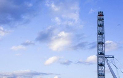 Low angle view of tower against cloudy sky