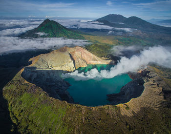 Scenic view of smoke emitting from lake in volcanic crater