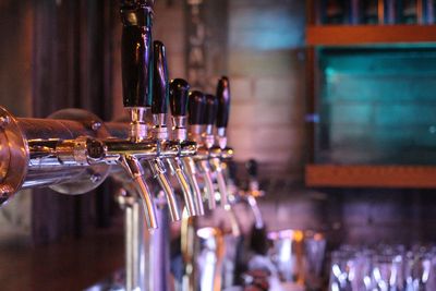 Close-up of beer taps at bar