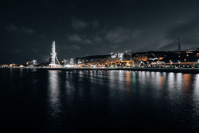 Illuminated city at waterfront