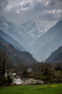 Scenic view of landscape and mountains against sky