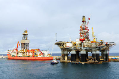 Offshore platform amidst sea against sky