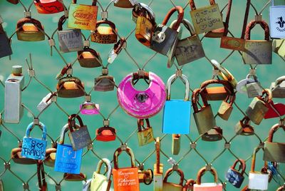 Colorful padlocks attached on fence