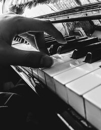 Close-up of man playing piano