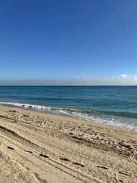 Scenic view of sea against clear blue sky