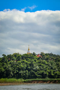 View of temple building against cloudy sky