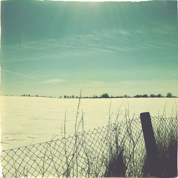 sky, tranquility, fence, tranquil scene, nature, field, scenics, landscape, beauty in nature, blue, outdoors, day, cloud - sky, no people, plant, protection, water, cloud, safety, grass