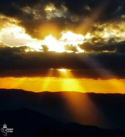 Scenic view of silhouette mountains against sky during sunset