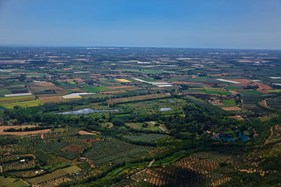 Aerial view of agricultural field against clear sky