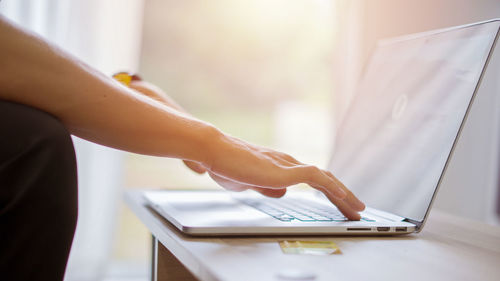 Midsection of man using laptop