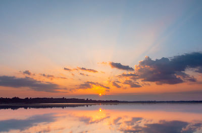 Scenic view of lake against romantic sky at sunset