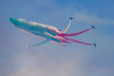 Low angle view of airshow against sky