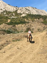 Full length of woman riding on mountain