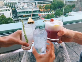 Close-up of hands holding cocktail drinks