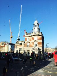 View of city street against blue sky