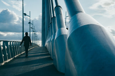 Man walking on staircase against sky