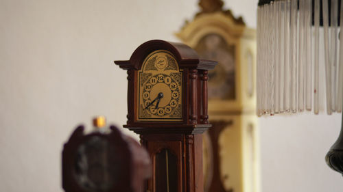 Close-up of clock tower against wall