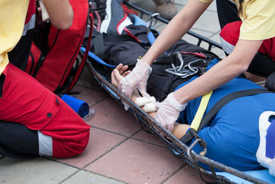 High angle view of paramedics treating man on stretcher