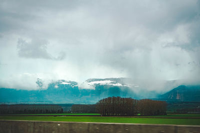 Panoramic view of field against sky during rainy season