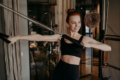 Smiling woman exercising at gym