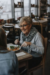 Woman sitting on table at restaurant