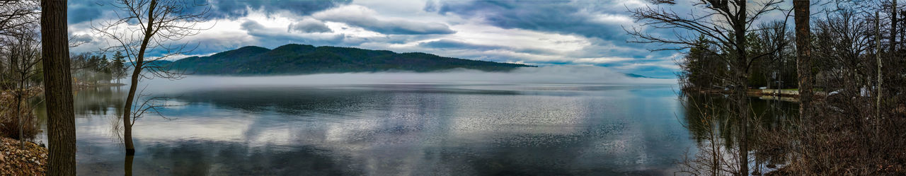 Scenic view of lake against sky during winter