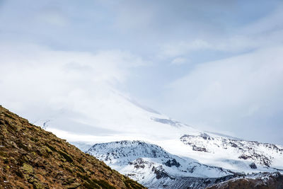 Elbrus national park, russia. slope of mount elbrus. top of mountain is partially hidden by cloud