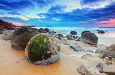 Scenic view of beach against sky during sunset