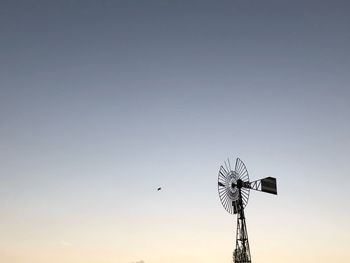 Low angle view of crane against clear sky