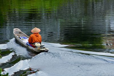 Man sitting in boat on lake