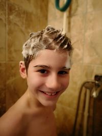 Smiling boy bathing n bathroom