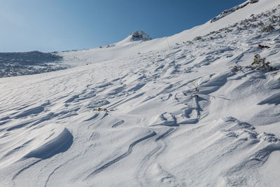 Scenic view of snow covered mountains against sky