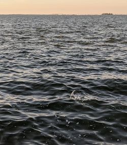 Scenic view of sea against clear sky during sunset