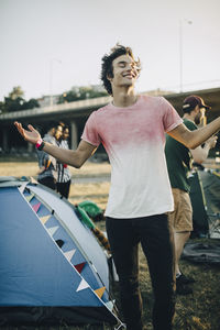 Man with arms outstretched enjoying music at concert