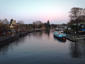 Boats in river with buildings in background