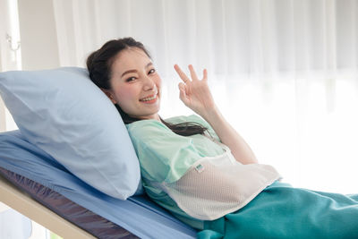 Young woman lying on bed at home