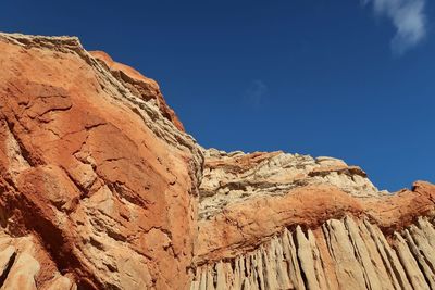 Low angle view of rock formation against clear blue sky