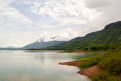 Scenic view of lake and mountains against sky