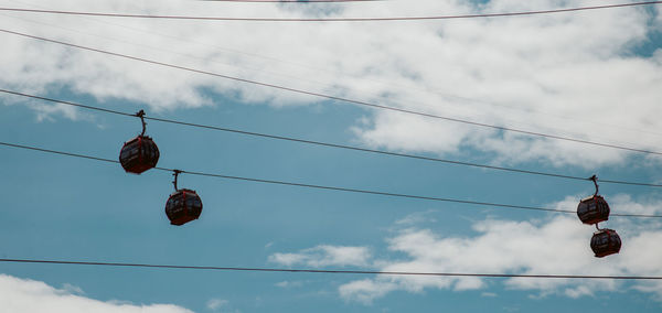 Low angle view of lanterns hanging against sky