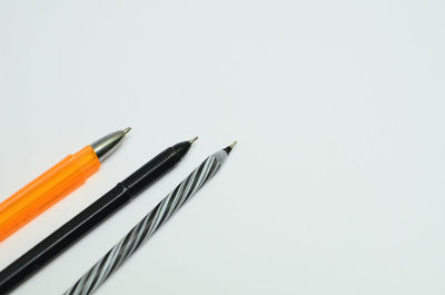 High angle view of colored pencils on white background