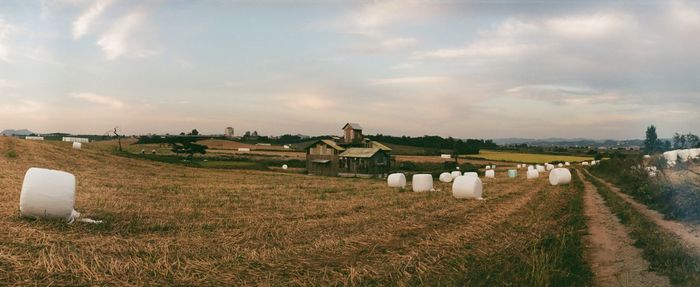 Rural landscape against cloudy sky