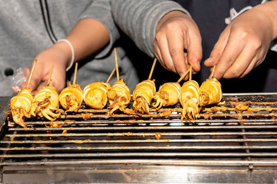 Man working on barbecue grill