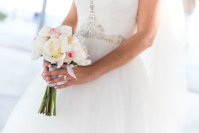 Midsection of woman holding flower bouquet