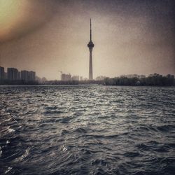 View of communications tower and buildings in city