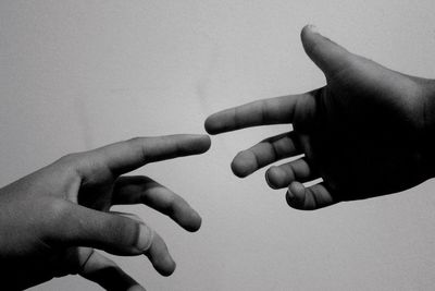 Close-up of hands over white background