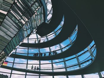 Low angle view of people walking on walkway at reichstag building