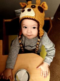 Portrait of cute girl sitting at home