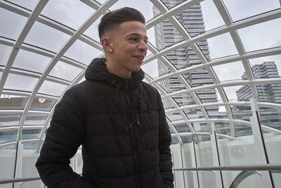 Low angle view of smiling man standing indoors