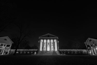 Low angle view of illuminated building against sky at night